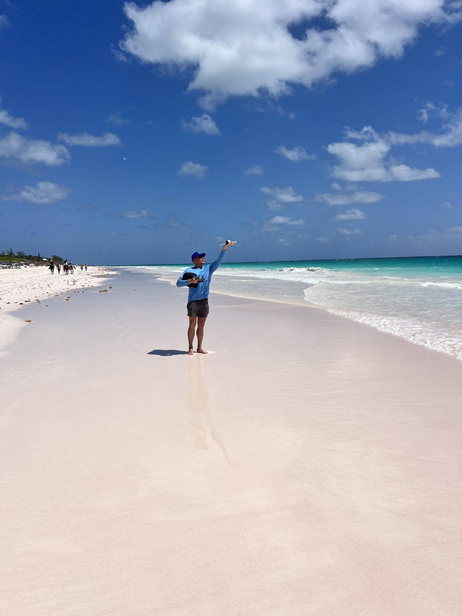 Nate Keag catching his drone on Pink Sands Beach, Harbour Island