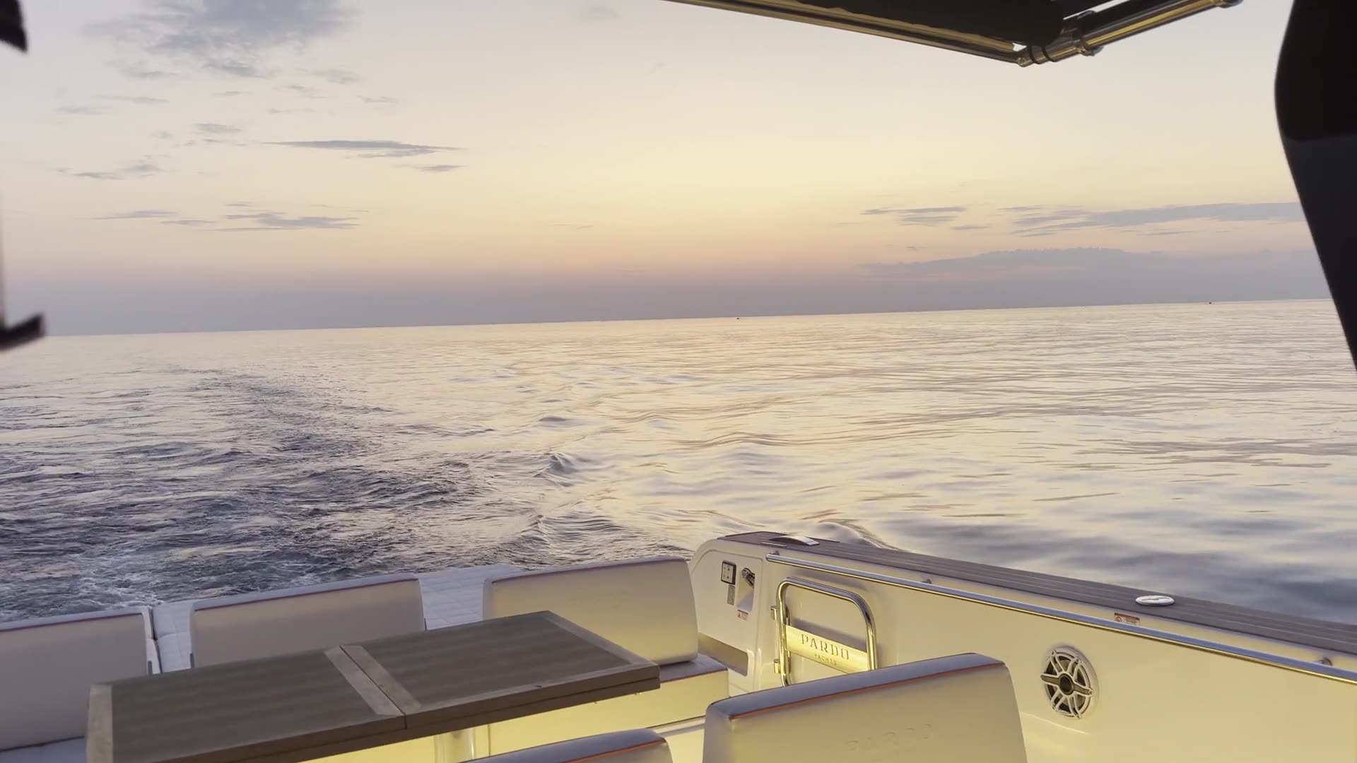 The wake behind the boat at dusk on Lake Michigan